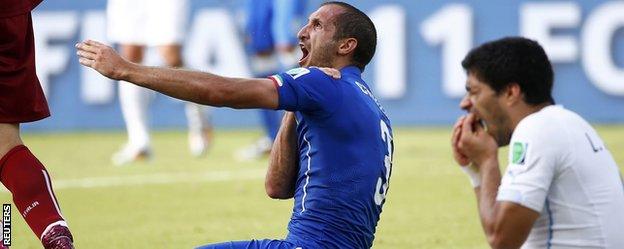 Italy's Giorgio Chiellini and Luis Suarez