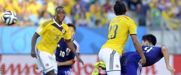 Japan forward Shinji Okazaki's heads in a goal for his side against Colombia