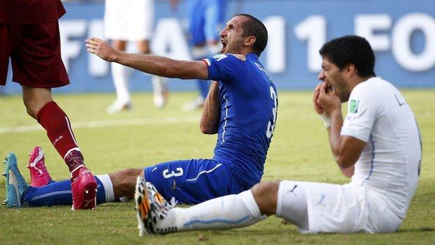 Italy's Giorgio Chiellini and Luis Suarez of Uruguay