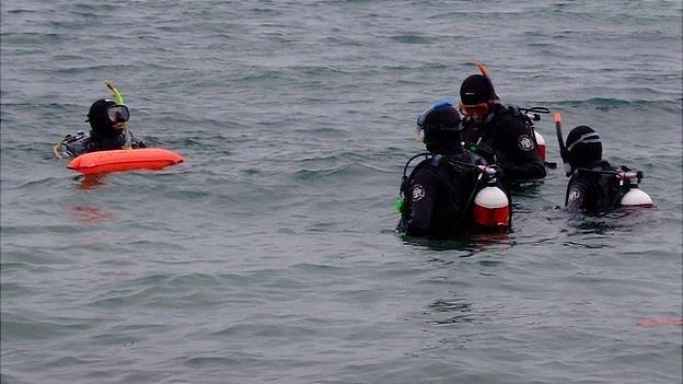 Divers in Guernsey's St Peter Port Harbour