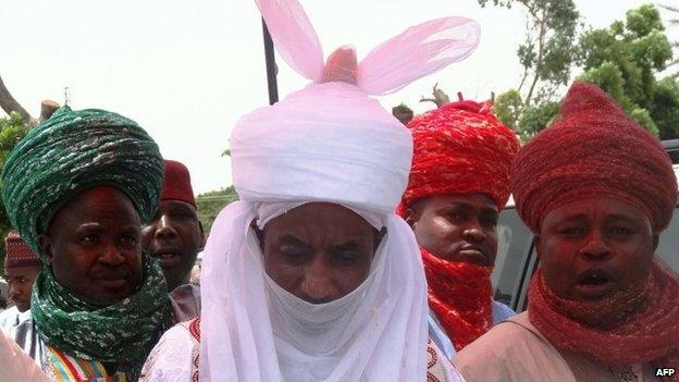 The new emir of the northern Nigerian city of Kano Lamido Sanusi (C) walks in Kano on 9 June 2014