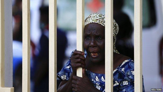A woman reacts as injured victims arrive at the Maitama general hospital in Abuja on 25 June 2014.