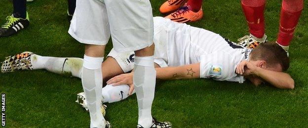 France defender Lucas Digne lays on the ground after a challenge from Ecuador's Antonio Valencia