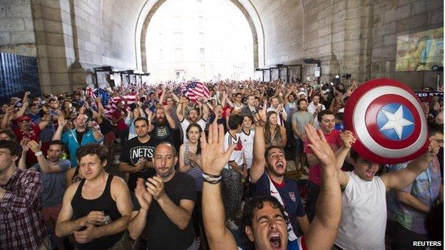 US soccer fans cheer at the start of the team's 2014 World Cup Group G soccer match against Germany at a viewing party under the Manhattan Bridge in New York 26 June 2014