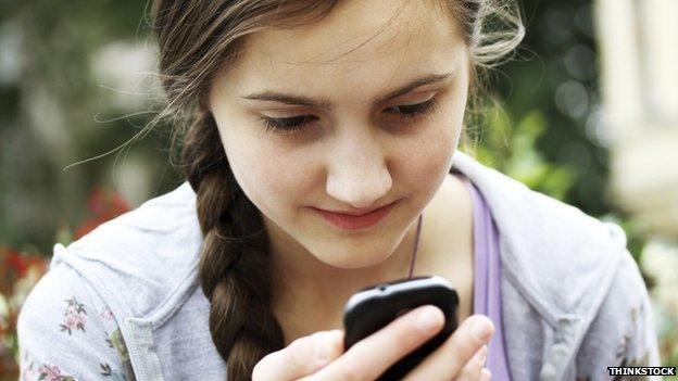 Young girl using mobile - posed by model