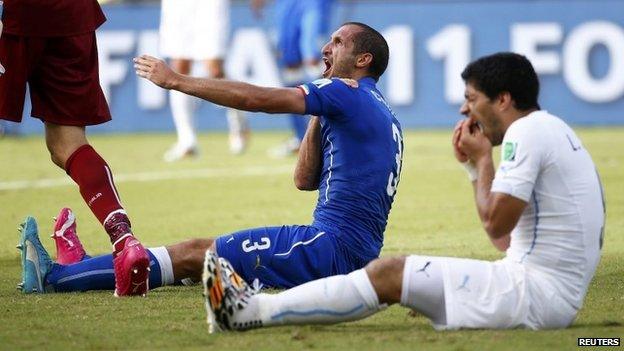 Italian defender Giorgio Chiellini and Luis Suarez shortly after clashing. 25/06/2014