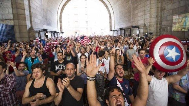 US soccer fans cheer at the start of the team"s 2014 World Cup Group G soccer match against Germany at a viewing party under the Manhattan Bridge in New York 26 June 2014