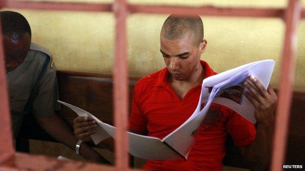 British terror suspect Jermaine John Grant reads a evidence report complied by the UK police officers at a court in Mombasa, Kenya - 20 June 2014