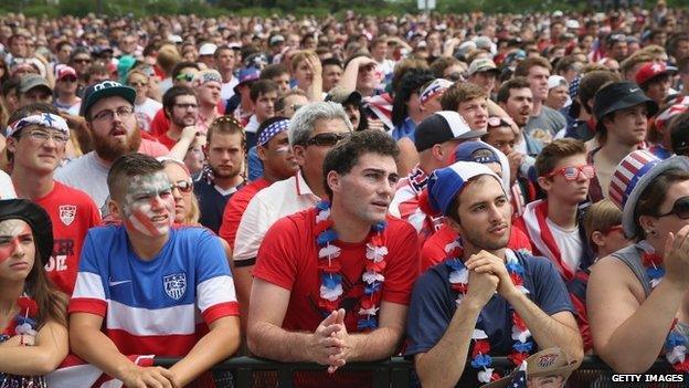 Fans watch USA play Germany in a World Cup soccer match on one of two large screens placed for fans in Grant Park in Chicago, Illinois 26 June 2014