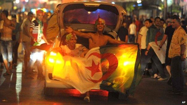 Algerian football fans celebrate in the streets of Algiers, Algeria