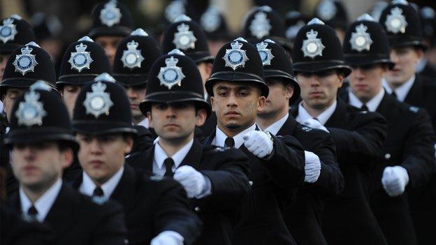 Newly qualified police officers take part in a passing out parade