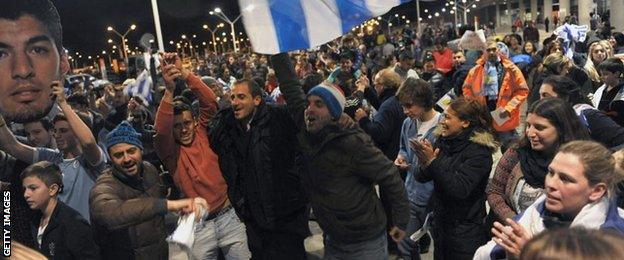 Fans wait for Luis Suarez at Carrasco International Airport near Montevideo