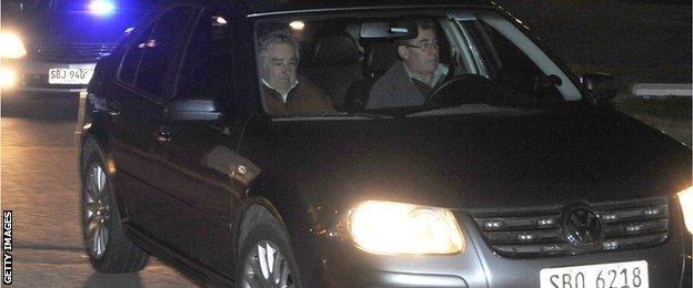 Uruguay's President Jose Mujica (L) leaves in a private car at the Carrasco international airport