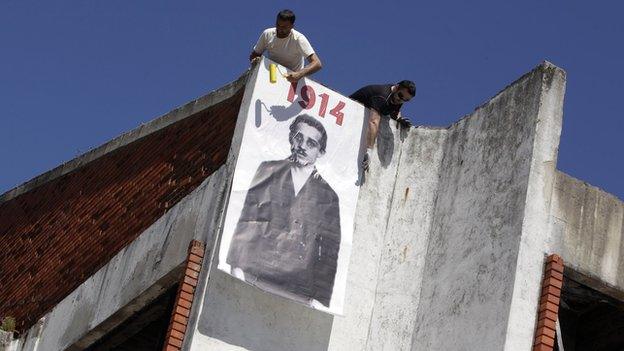 People put up a poster of Gavrilo Princip in Bosansko Grahovo, near his birth village in Obljaj, on 27 June 2014.