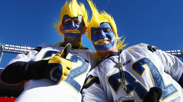 Two San Diego Chargers fans dress up for a game.