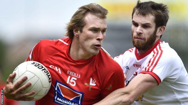 Conor Grimes of Louth in action against Ronan McNamee of Tyrone