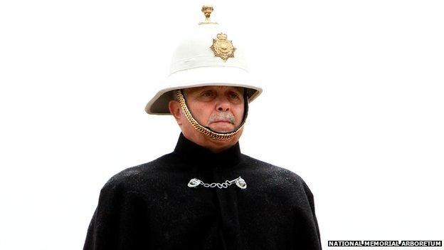 A bugler stands to attention