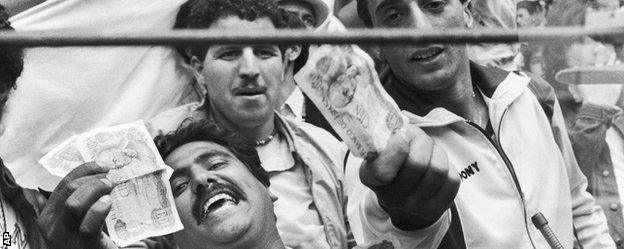 Algeria fans show money to photographers following their controversial exit form the 1982 World Cup