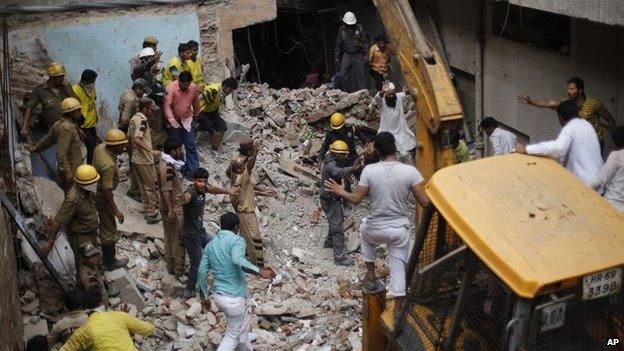 Rescue search through the rubble in Delhi. Photo: 28 June 2014