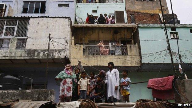 Neighbours watch rescue efforts after collapse of building in Delhi - 28 June