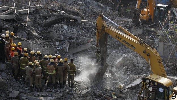 Heavy machinery removes rubble after the building collapse in Chennai - 29 June