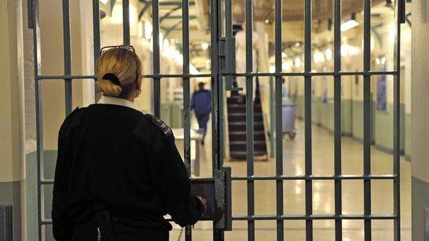 A prison officer locks a door at Wormwood Scrubs, a category B prison in London