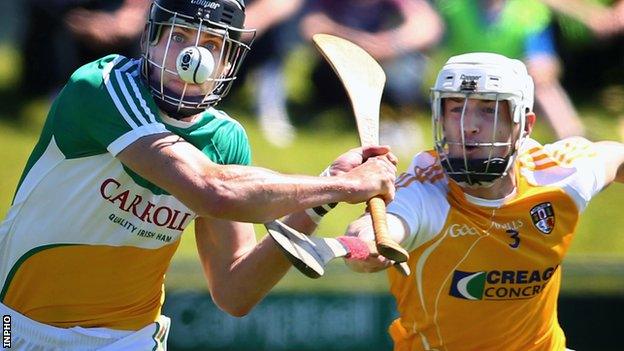 Offaly's Conor Mahon is challenged by Antrim defender Conor McKinley