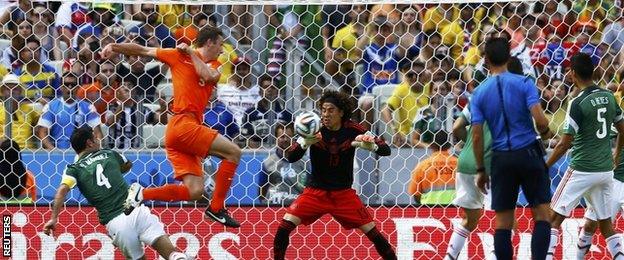 Guillermo Ochoa makes a save from Stefan de Vrij