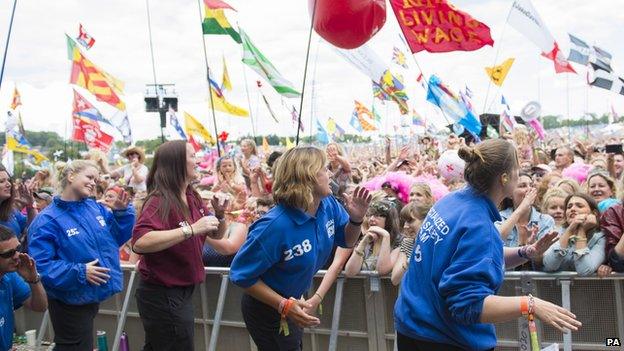 Security staff dancing to Dolly Parton at Glastonbury 2014