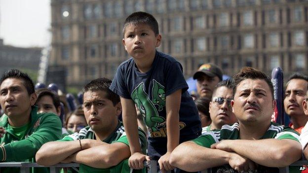 Mexican supporters watch the match at the Zocalo square