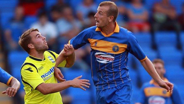 Birmingham City's Andrew Shinnie (left) challenges Shrewsbury's Luke Summerfield