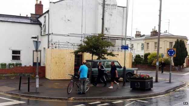 Scaffolding and hoarding erected around the Banksy "Spy Booth" artwork in Cheltenham