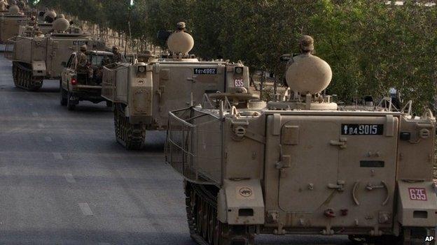 Pakistani army troops ride military vehicles following an operation launched against the Taliban in North Waziristan, in Karachi, Pakistan, Monday, June 16, 2014.