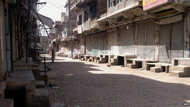 A Pakistani tribesperson is pictured along a shuttered market in Miranshah in North Waziristan, a stronghold for Taliban and Al-Qaeda-linked militants near the border with Afghanistan, on June 15, 2014,