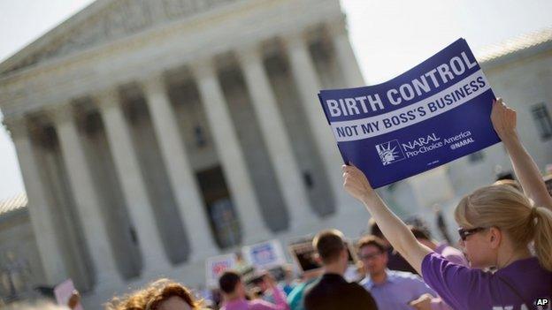 A demonstrator held up a sign in front of the Supreme Court in Washington on 30 June 2014