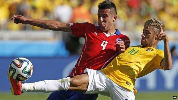 Brazil's Neymar, right, fights for the ball with Chile's Mauricio Isla during their World Cup match at Mineirao Stadium in Belo Horizonte, Brazil, on 28 June 2014