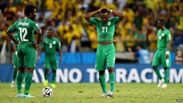 A dejected Wilfried Bony (L) and Giovanni Sio of Ivory Coast react during the 2014 World Cup match between Greece and the Ivory Coast at Castelao on 24 June 2014 in Fortaleza, Brazil