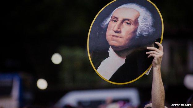 Before the match between Ghana and USA, a fan held up a poster of George Washington