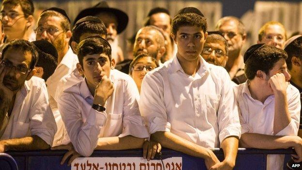 Israelis gather in Elad, outside the house of Eyal Yifrach, one the three missing teenagers, on 30 June 2014