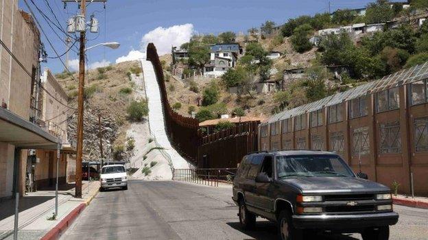 A steel border fence separates Nogales, Arizona, from its sister city in Sonora, Mexico 25 June 2014