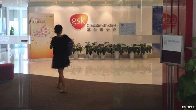 File photo: A Chinese employee walks into a GlaxoSmithKline (GSK) office in Beijing, 19 July 2013