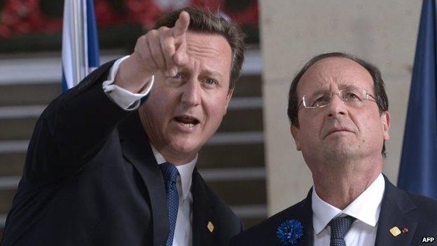 File photo: British Prime Minister David Cameron (left) and French President Francois Hollande gesture during a ceremony to mark the 100th anniversary of the outbreak of World War I in Ypres, 26 June 2014