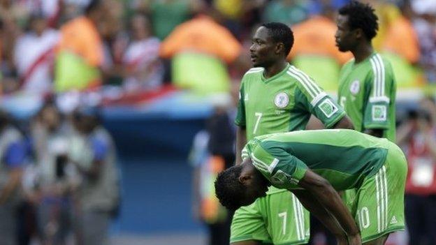 Nigeria"s players react in dejecting at the end of the World Cup round of 16 soccer match between France and Nigeria at the Estadio Nacional in Brasilia, Brazil, Monday, June 30, 2014