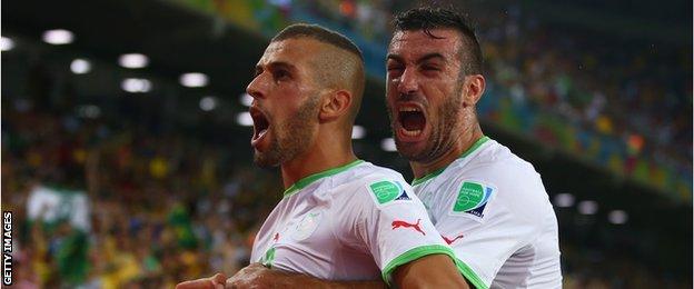 Islam Slimani of Algeria celebrates with Essaid Belkalem