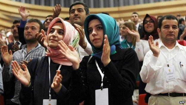 Supporters of Turkish PM Recep Tayyip Erdogan clap as he announces his candidacy for presidential elections in Ankara on 1 July 2014.