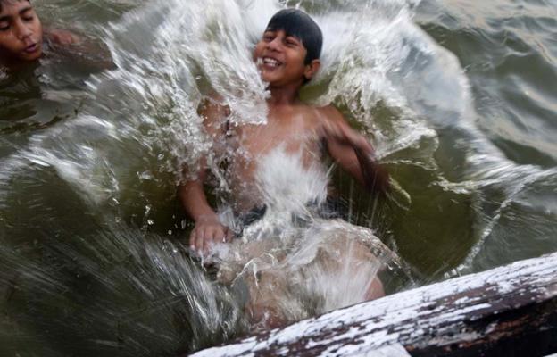 Boy splashing in the Ganges