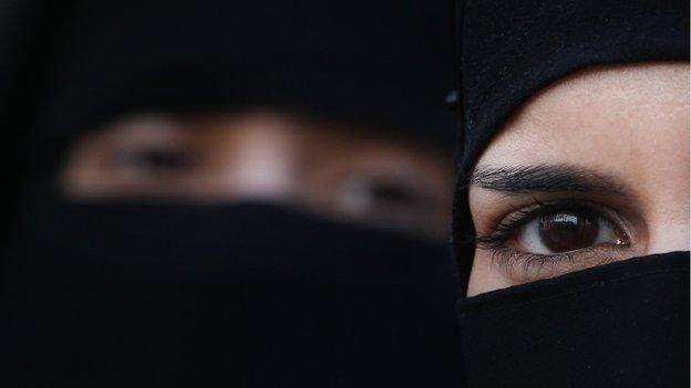 Two women wearing Islamic niqab veils stand outside the French Embassy during a demonstration on 11 April 2011 in London, England.