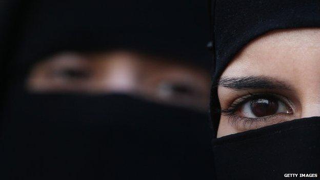 Two women wearing Islamic niqab veils stand outside the French Embassy during a demonstration on 11 April 2011 in London, England.