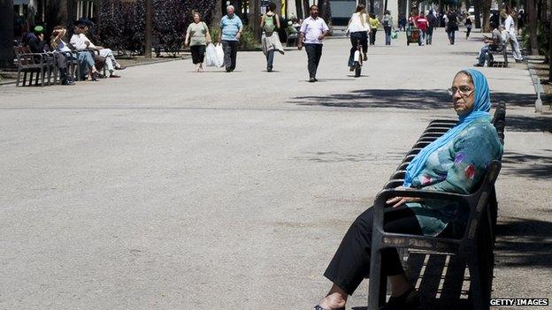 A veiled woman sits in a bench in Barcelona on 16 June 2010.