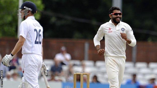 India's Ravindra Jadeja celebrates the wicket of Derbyshire's Ben Slater (left)